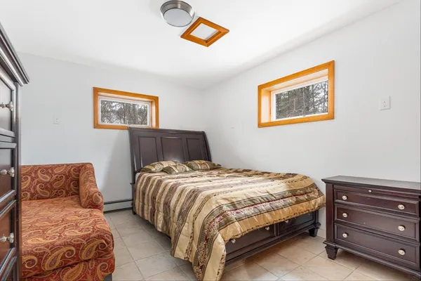 a bedroom with a bed and a couch