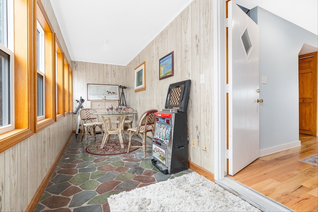 97 3rd Street North Edgartown, MA 02539 - Photo 20 of 27 a view of a dining room with furniture a chandelier and wooden floor