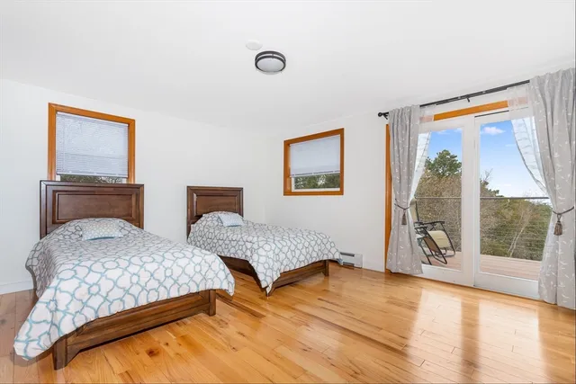 a bedroom with two beds and a large window