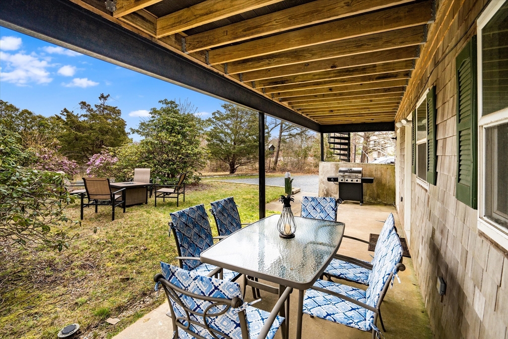 97 3rd Street North Edgartown, MA 02539 - Photo 5 of 27 a roof deck with table and chairs and potted plants