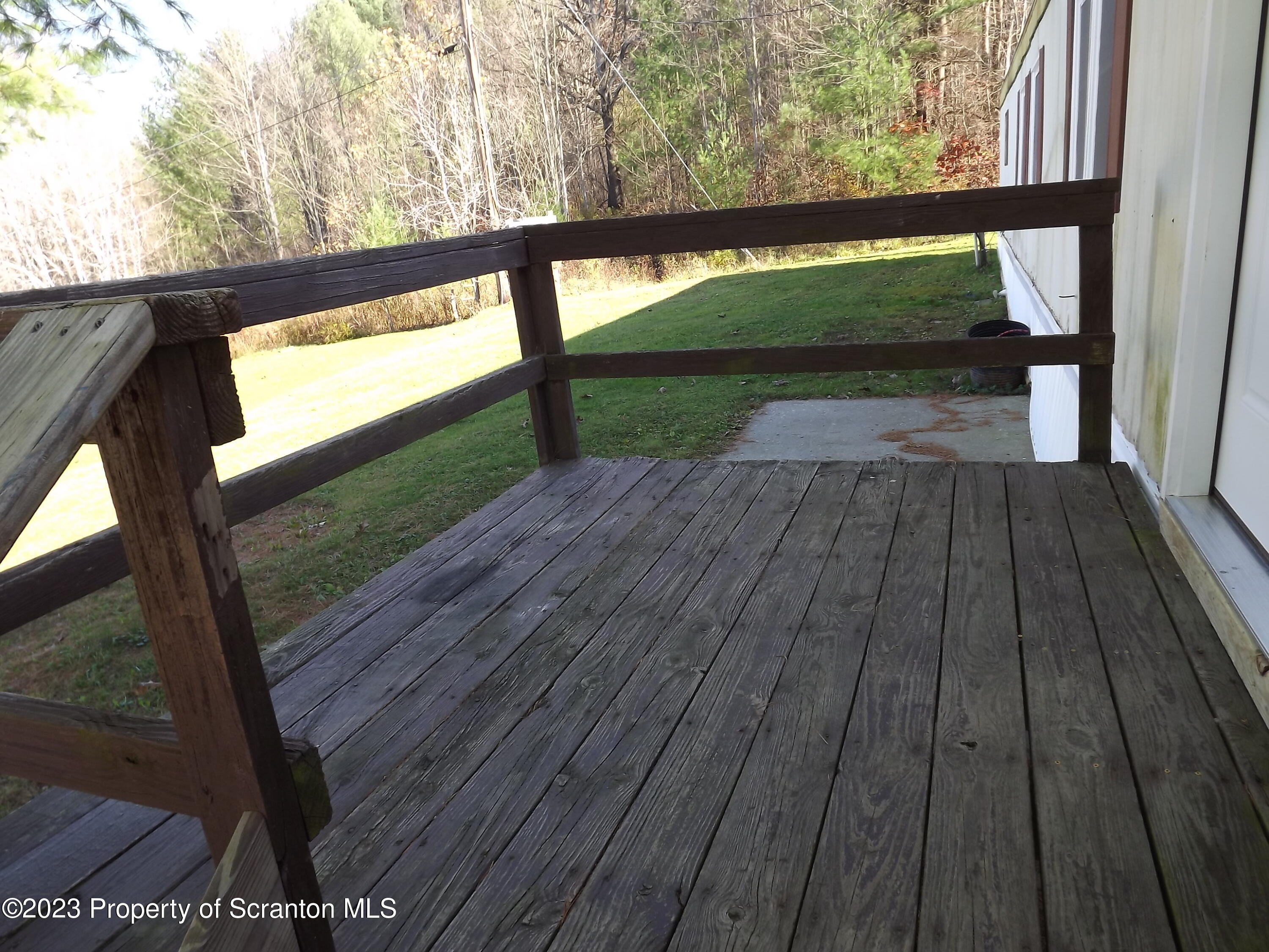 940 Nowlan Road, Unit 43 Port Crane, NY 13833 - Photo 5 of 13 a view of backyard with wooden floor and outdoor seating
