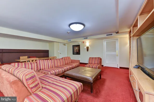 a bedroom with furniture and a flat screen tv