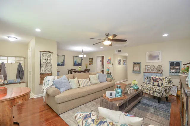 a living room with furniture and view of kitchen