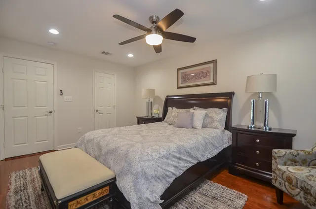 a bedroom with a bed and wooden floor