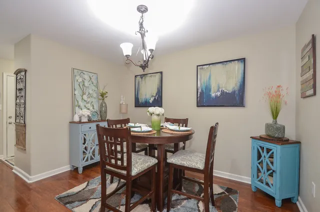 a view of a dining room with furniture wooden floor and a chandelier