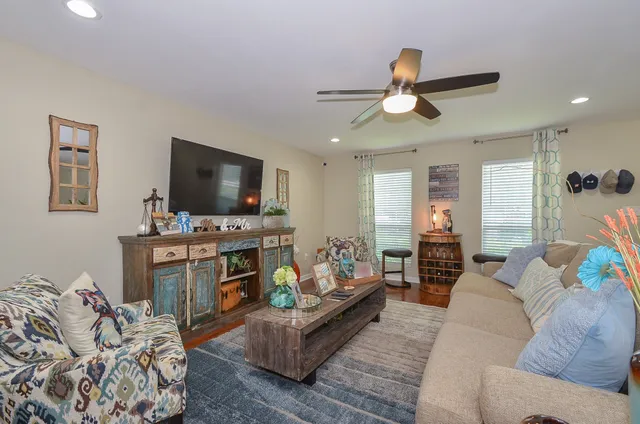 a living room with furniture and a flat screen tv