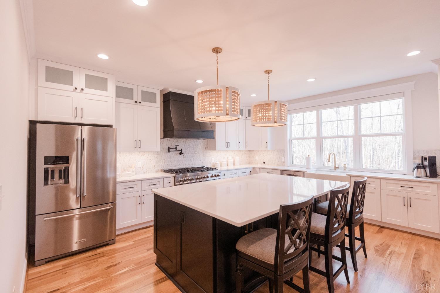 1401 Smartview Lane Forest, VA 24551 - Photo 18 of 46 a kitchen with a refrigerator a stove a sink dishwasher with a dining table and chairs