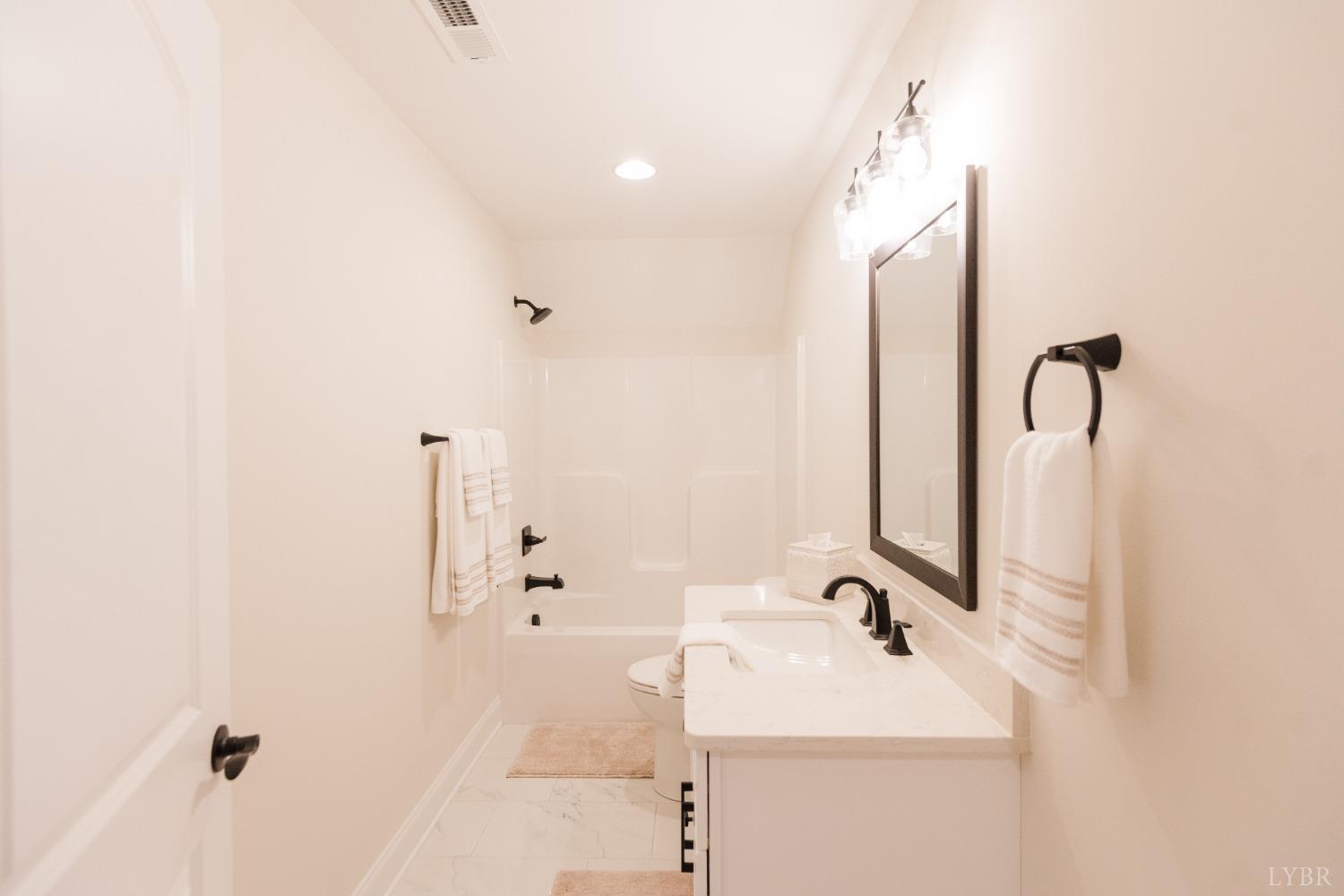 1401 Smartview Lane Forest, VA 24551 - Photo 26 of 46 a bathroom with a sink and mirror