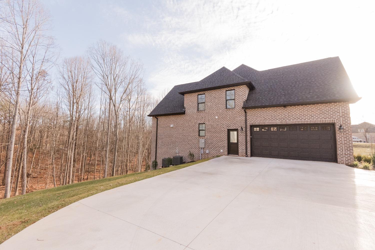 1401 Smartview Lane Forest, VA 24551 - Photo 5 of 46 a front view of a house with a yard and garage