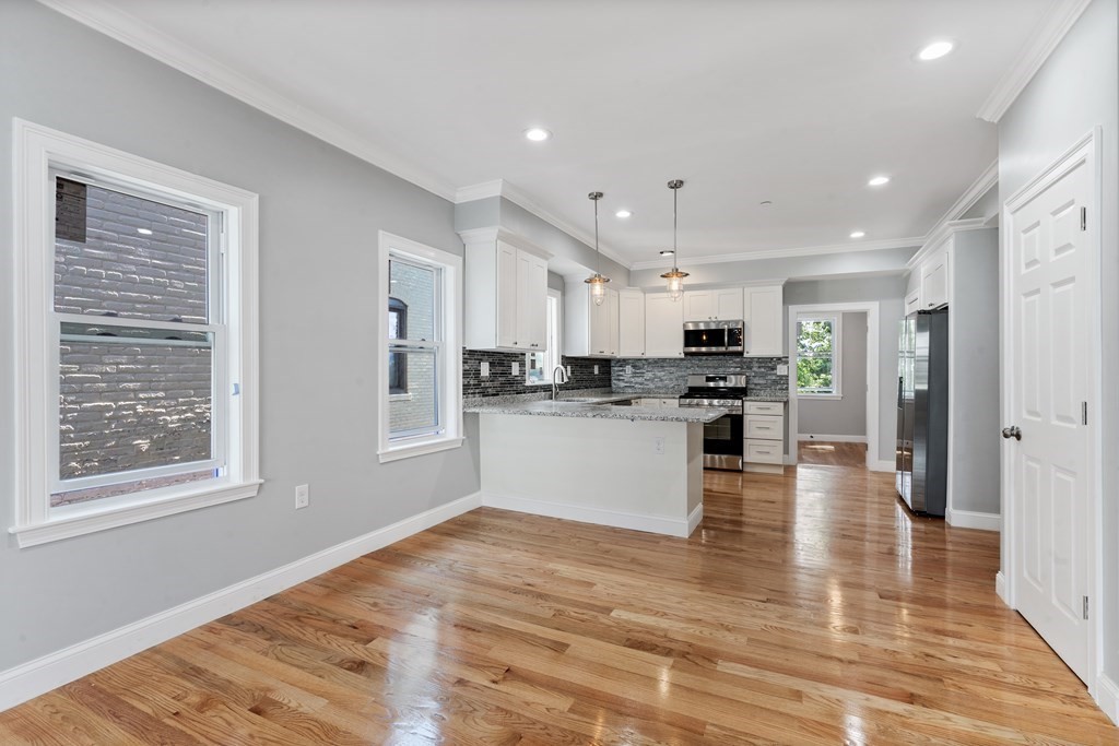 9 Wales Street, Unit 2 Boston, MA 02124 - Photo 11 of 15 a view of kitchen with kitchen island white cabinets and stainless steel appliances