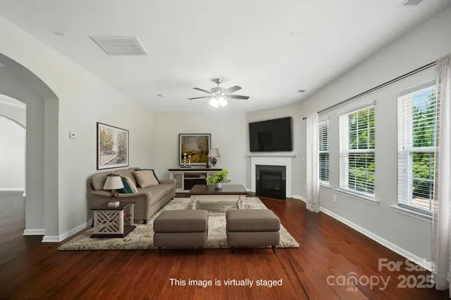 a living room with furniture fireplace and flat screen tv