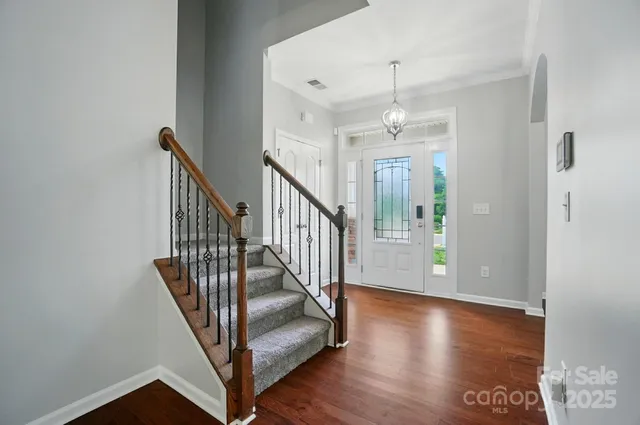 a view of a hallway with entryway wooden floor and front door