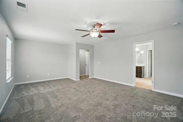 a view of an empty room with a ceiling fan