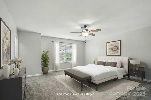 a bedroom with a large bed and potted plant