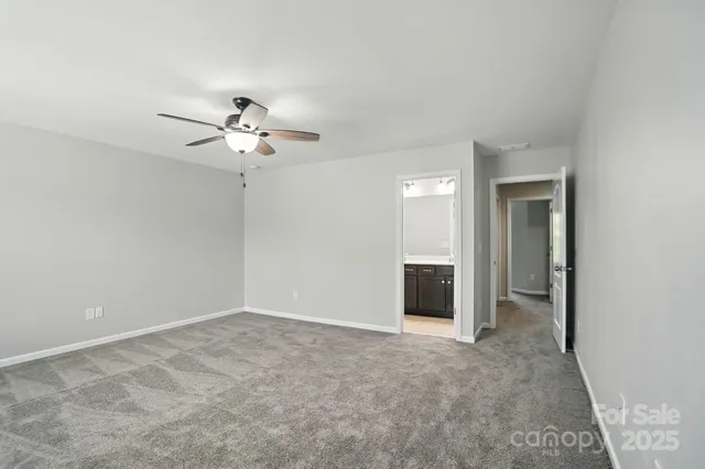 a view of an empty room with a ceiling fan