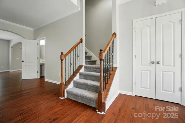 a view of entryway with wooden floor and stairs