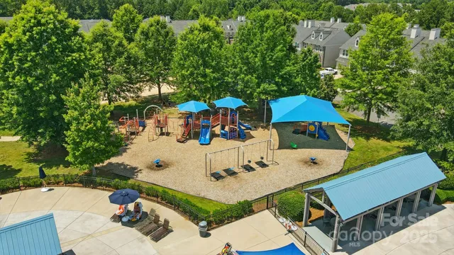 an aerial view of a house with swimming pool and big yard