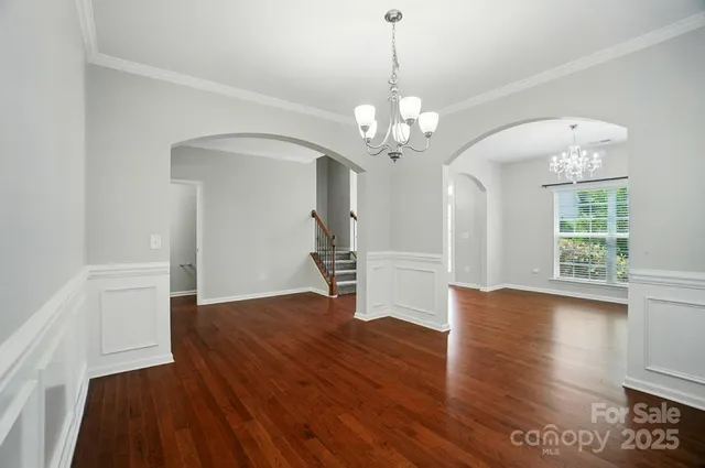 a view of a livingroom with wooden floor and a ceiling fan