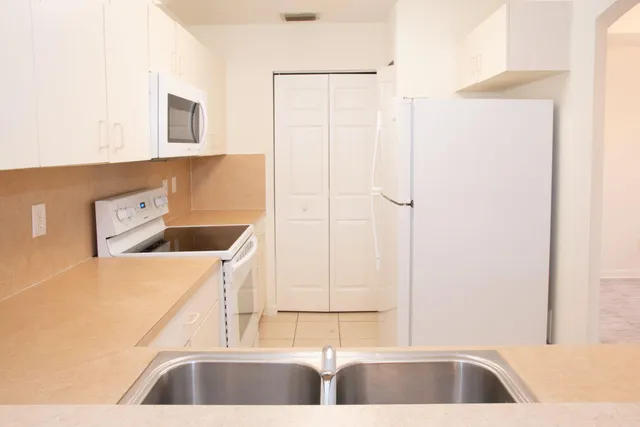 a kitchen with a sink and a refrigerator