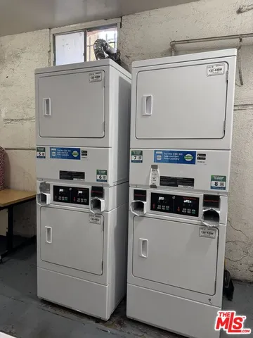 a utility room with cabinets washer and dryer