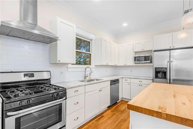 a kitchen with a stove a sink and a refrigerator