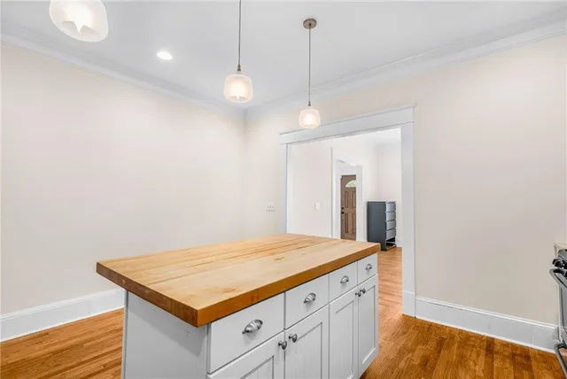 a kitchen with a stove and a wooden floor