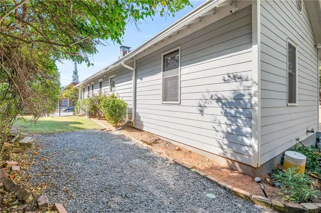 a view of a house with backyard and sitting area