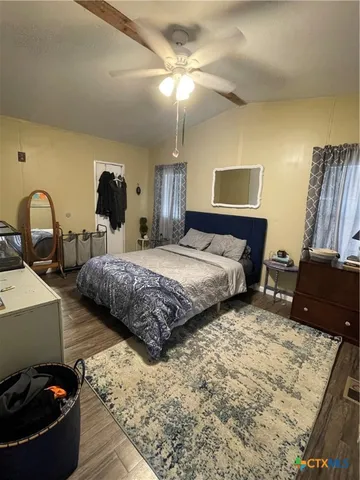 a bedroom with double bed and a couch