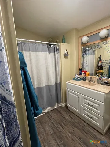 a bathroom with sink a mirror and shower