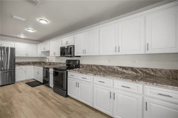 a kitchen with a refrigerator and a sink