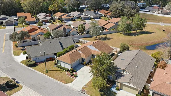 an aerial view of a house with swimming pool and outdoor seating
