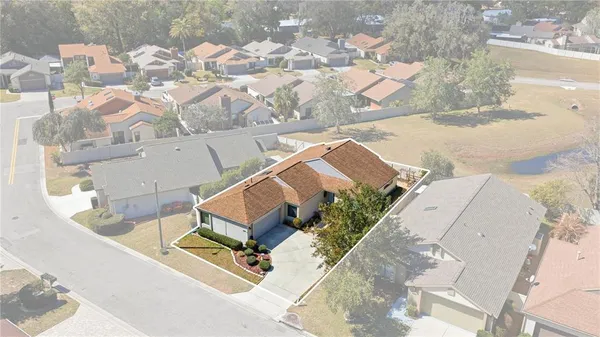 an aerial view of a house with a yard and a garage