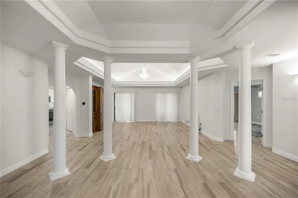 a view of an empty room with a kitchen