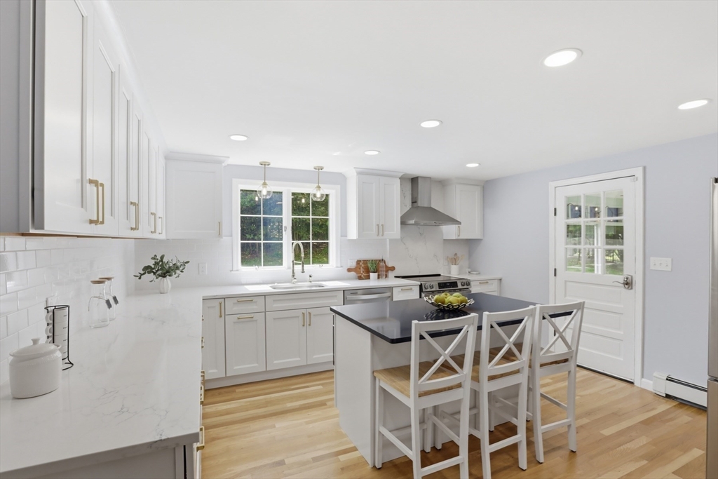 94 Johnson Road Winchester, MA 01890 - Photo 3 of 40 a kitchen with a sink dining table and chairs