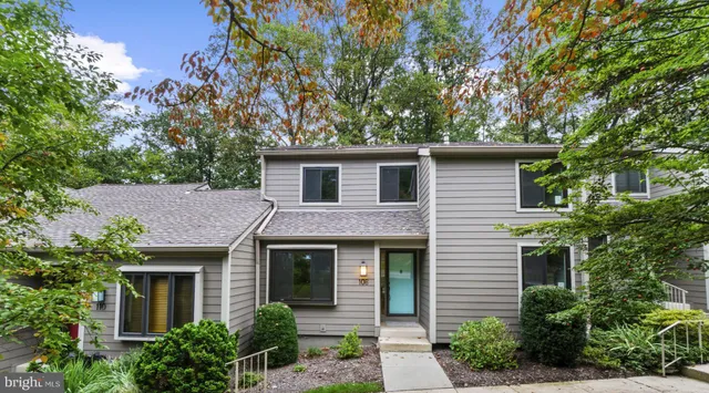 a front view of a house with yard and trees