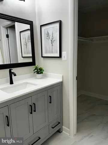 a bathroom with a sink and mirror
