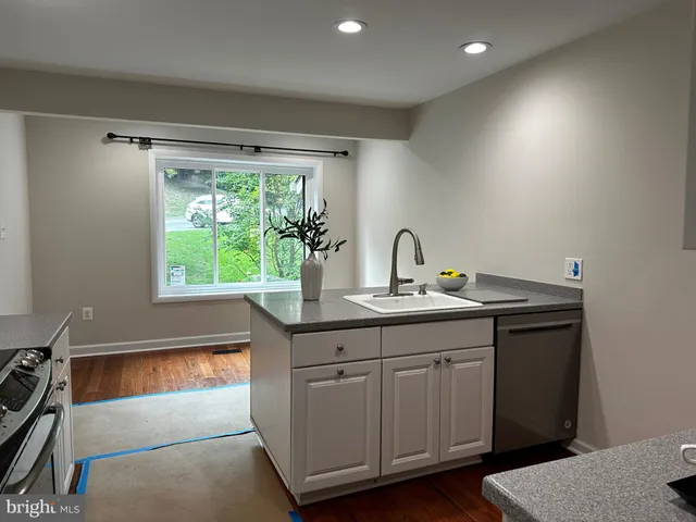 a kitchen with a sink and large window