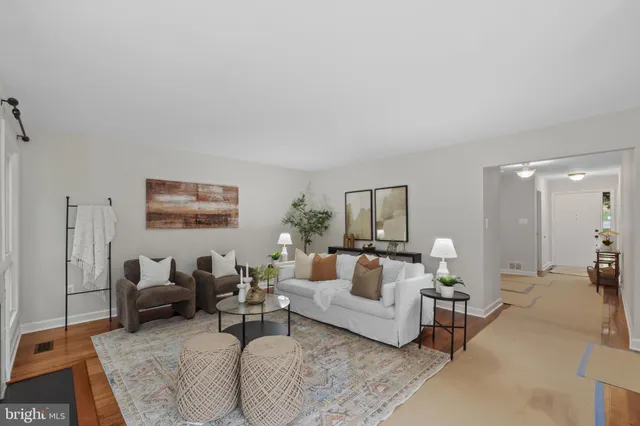 a view of a hallway with workspace and living room