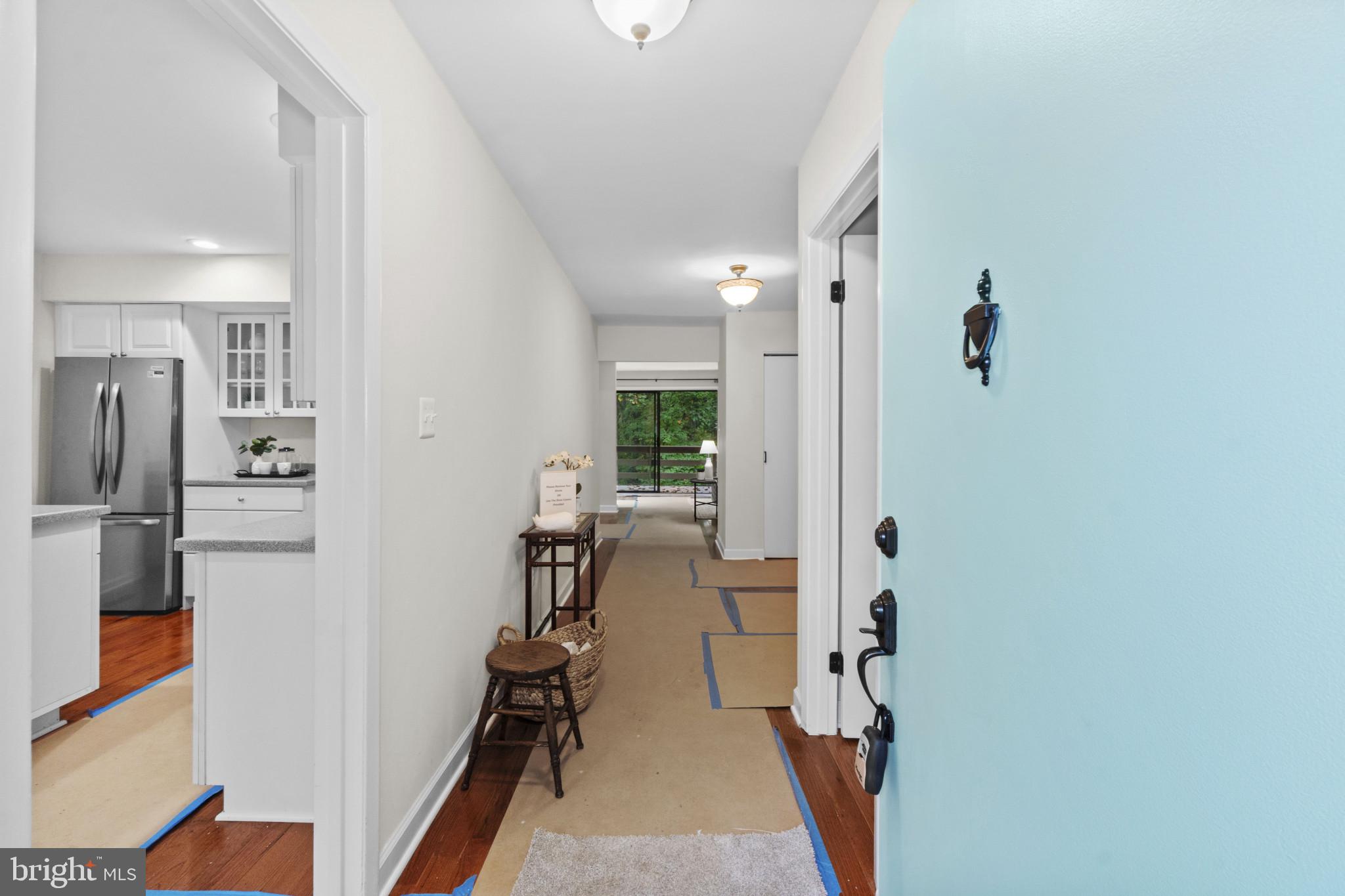 108 Beech Hill Lane, Unit 60 Baltimore, MD 21286 - Photo 4 of 27 a view of a hallway with workspace and living room