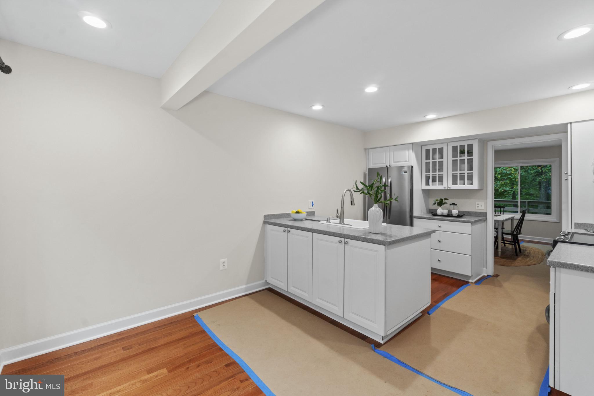 108 Beech Hill Lane, Unit 60 Baltimore, MD 21286 - Photo 7 of 27 a view of kitchen with white cabinets and white appliances