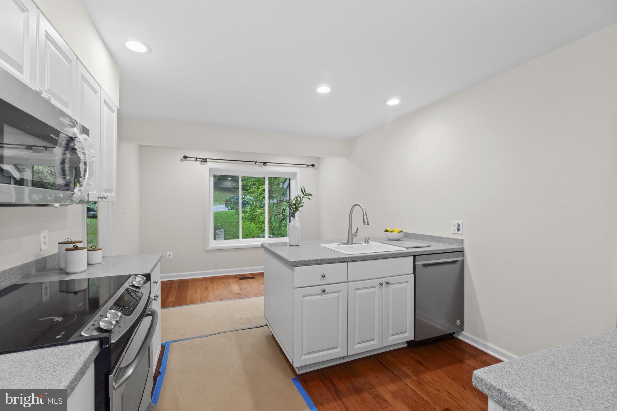 108 Beech Hill Lane, Unit 60 Baltimore, MD 21286 - Photo 8 of 27 a kitchen with a sink and wooden cabinets