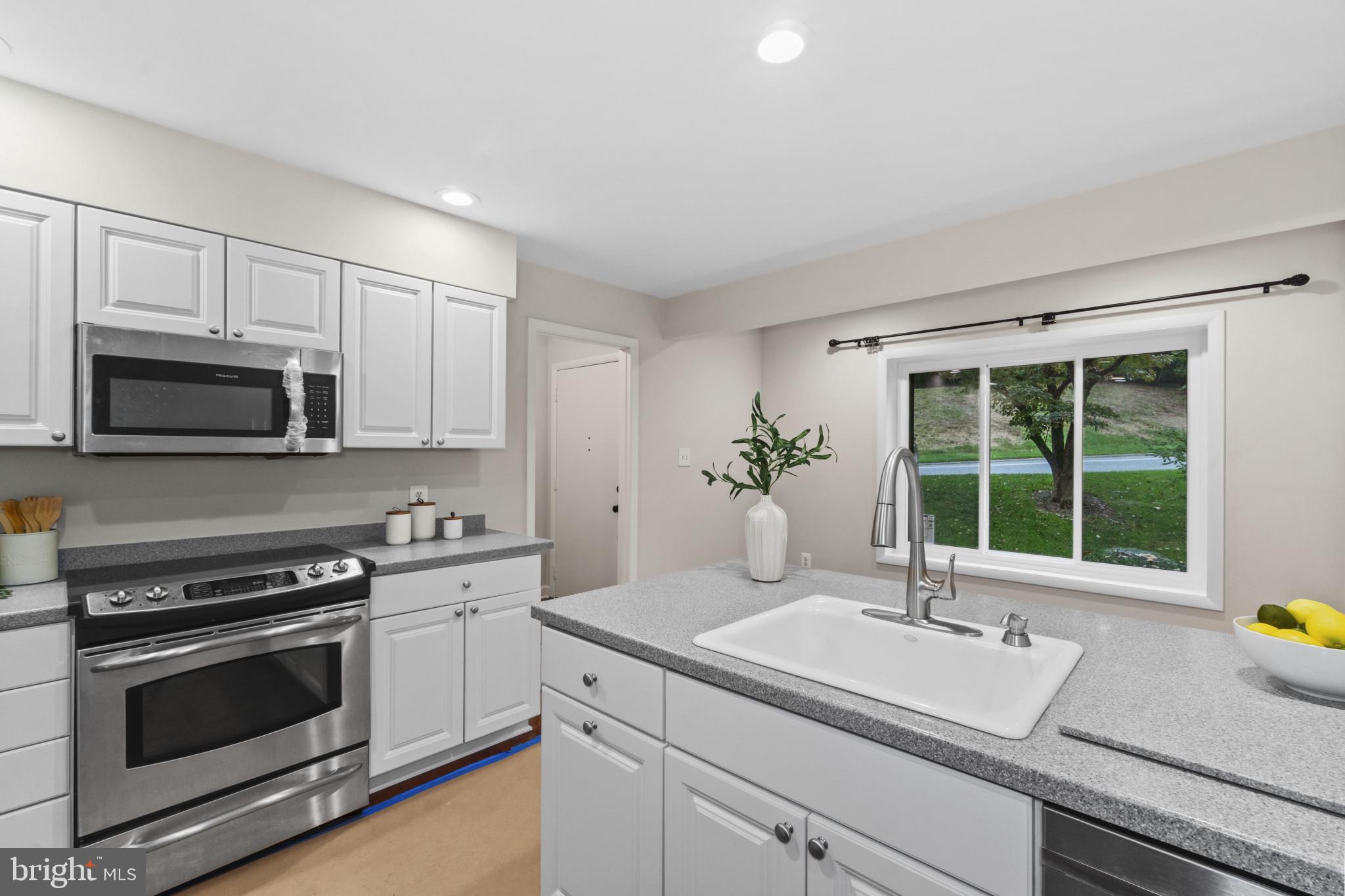 108 Beech Hill Lane, Unit 60 Baltimore, MD 21286 - Photo 9 of 27 a kitchen with a sink stove and microwave