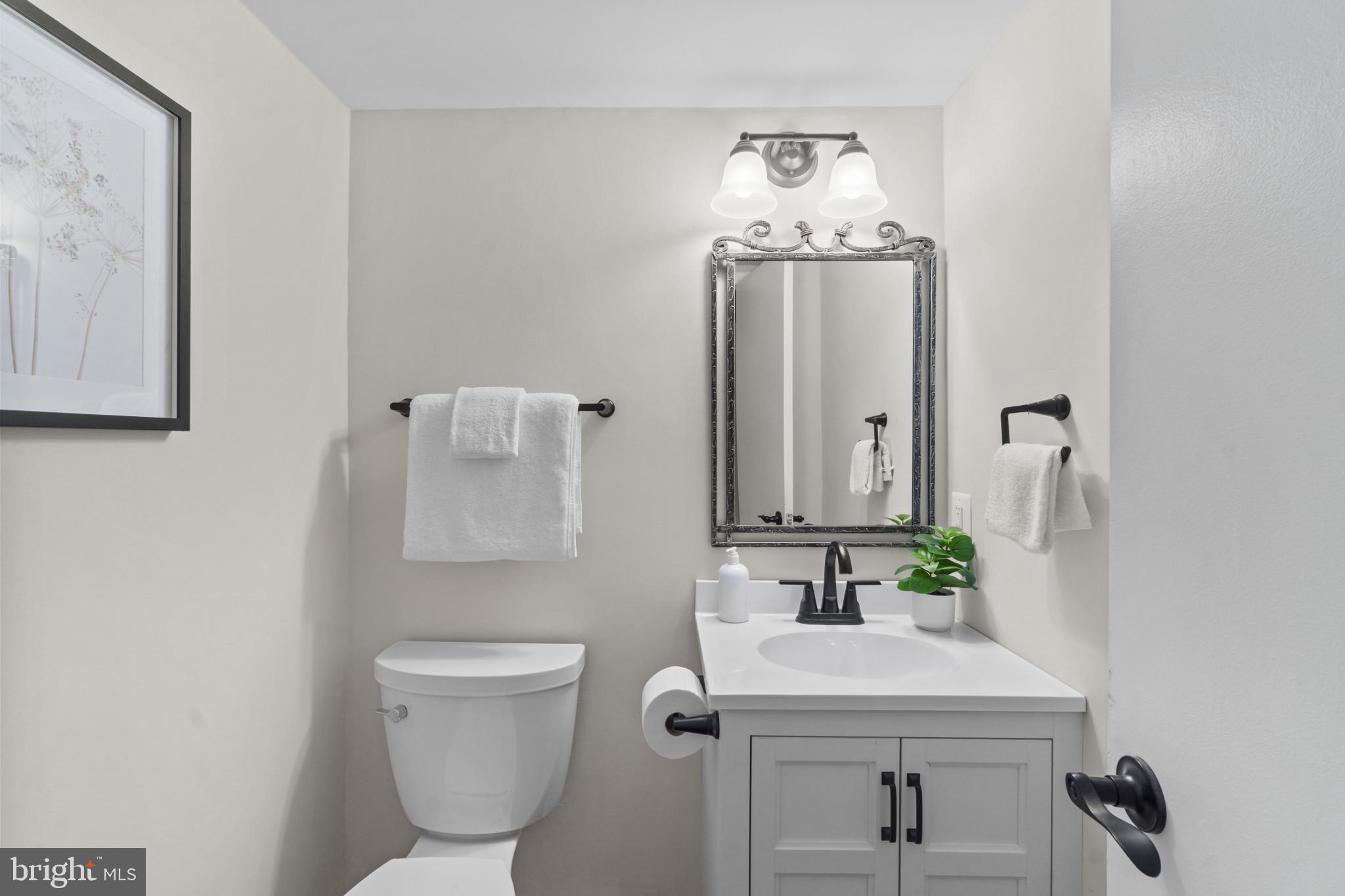 108 Beech Hill Lane, Unit 60 Baltimore, MD 21286 - Photo 10 of 27 a bathroom with a toilet sink and mirror