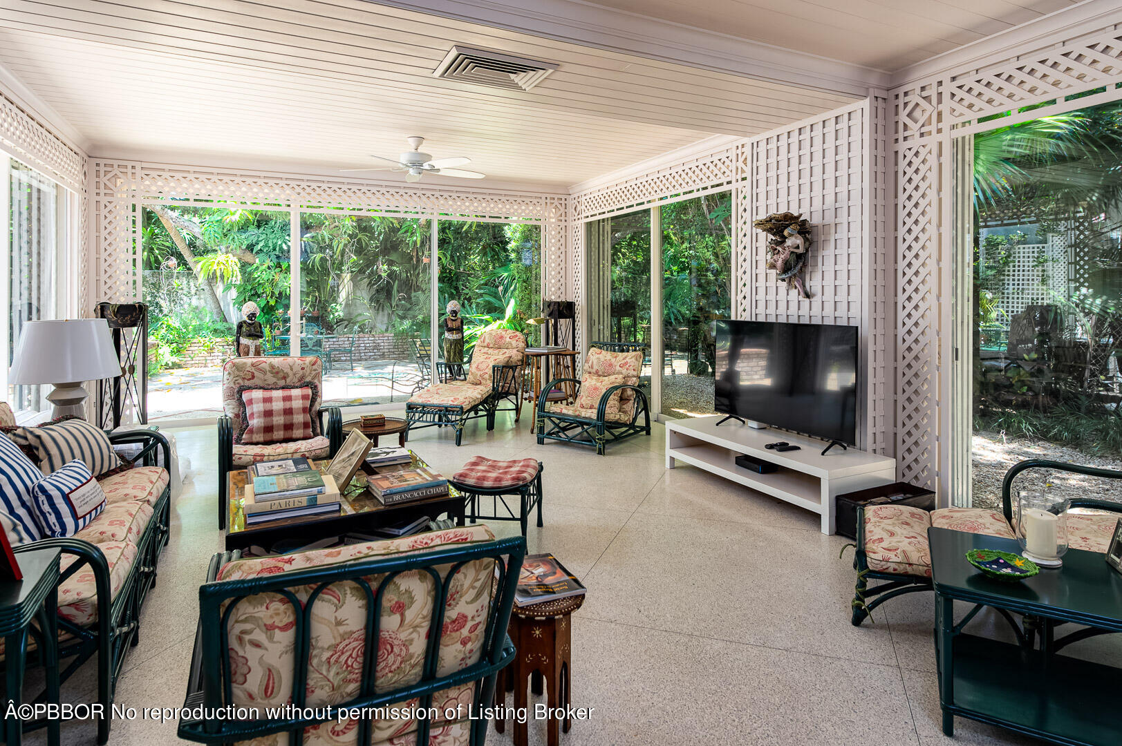 345 Pendleton Lane Palm Beach, FL 33480 - Photo 4 of 11 a living room with furniture a flat screen tv and a floor to ceiling window