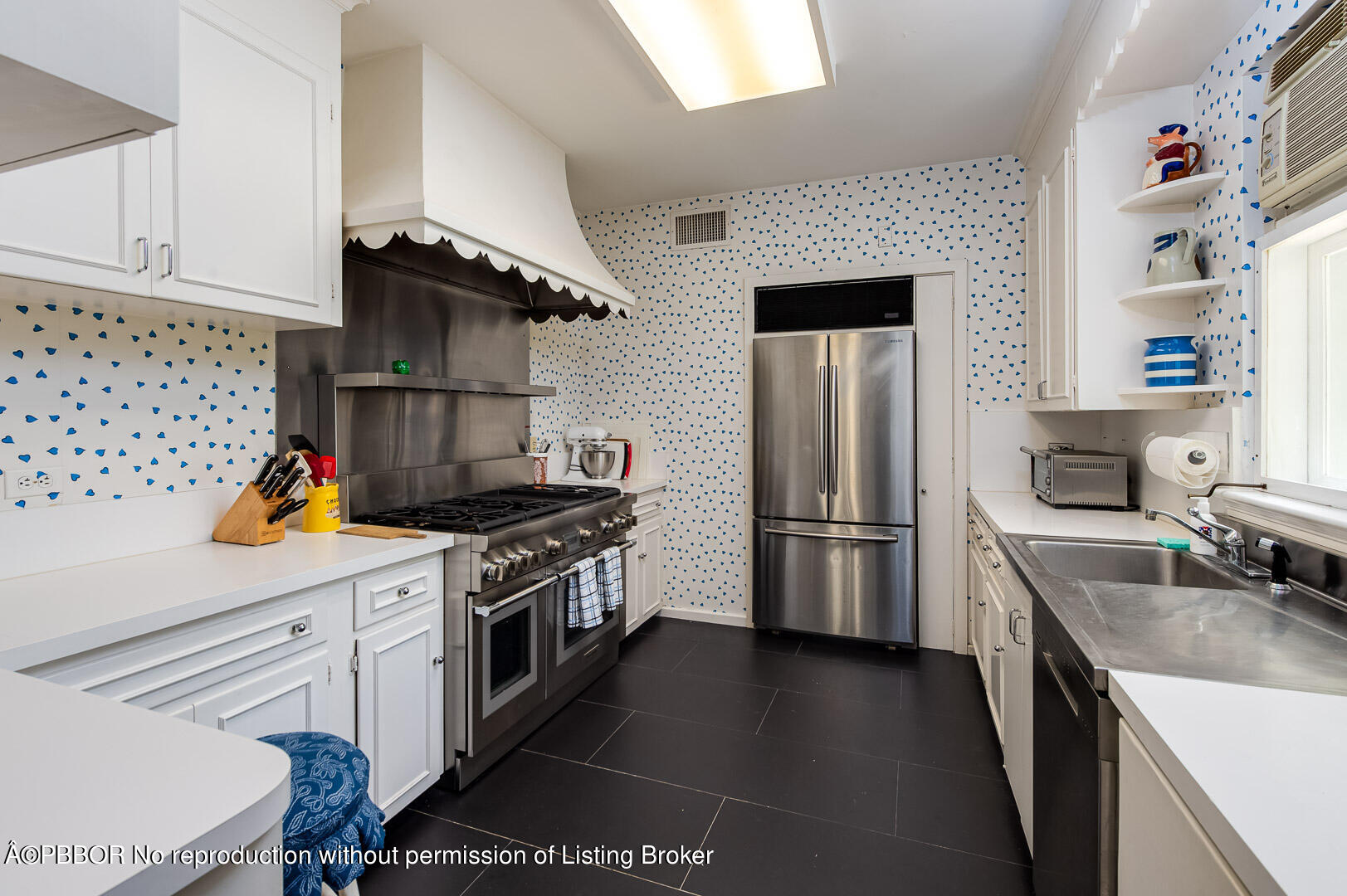 345 Pendleton Lane Palm Beach, FL 33480 - Photo 9 of 11 a kitchen with stainless steel appliances granite countertop a stove a refrigerator and a sink
