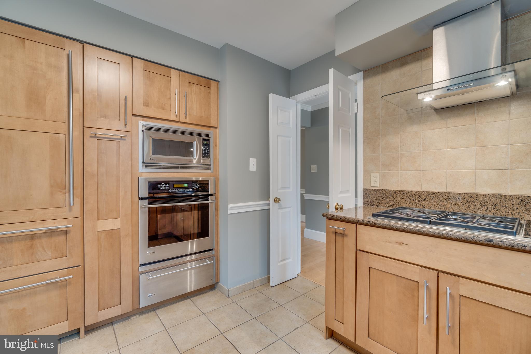 2069 Cobblestone Lane Reston, VA 20191 - Photo 8 of 35 a kitchen with white cabinets and white appliances