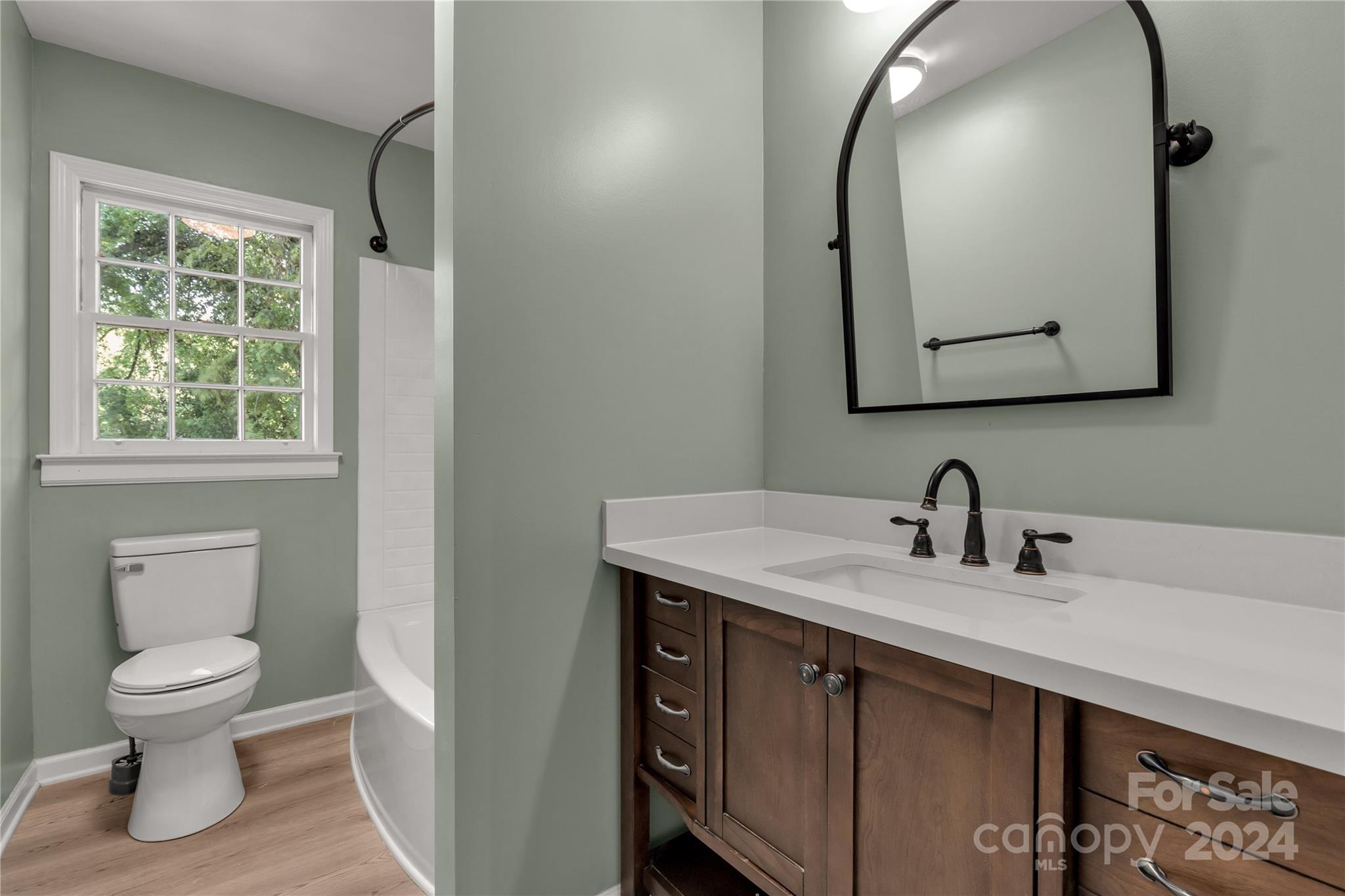 303 North White Street Lancaster, SC 29720 - Photo 12 of 24 a bathroom with a toilet sink and mirror