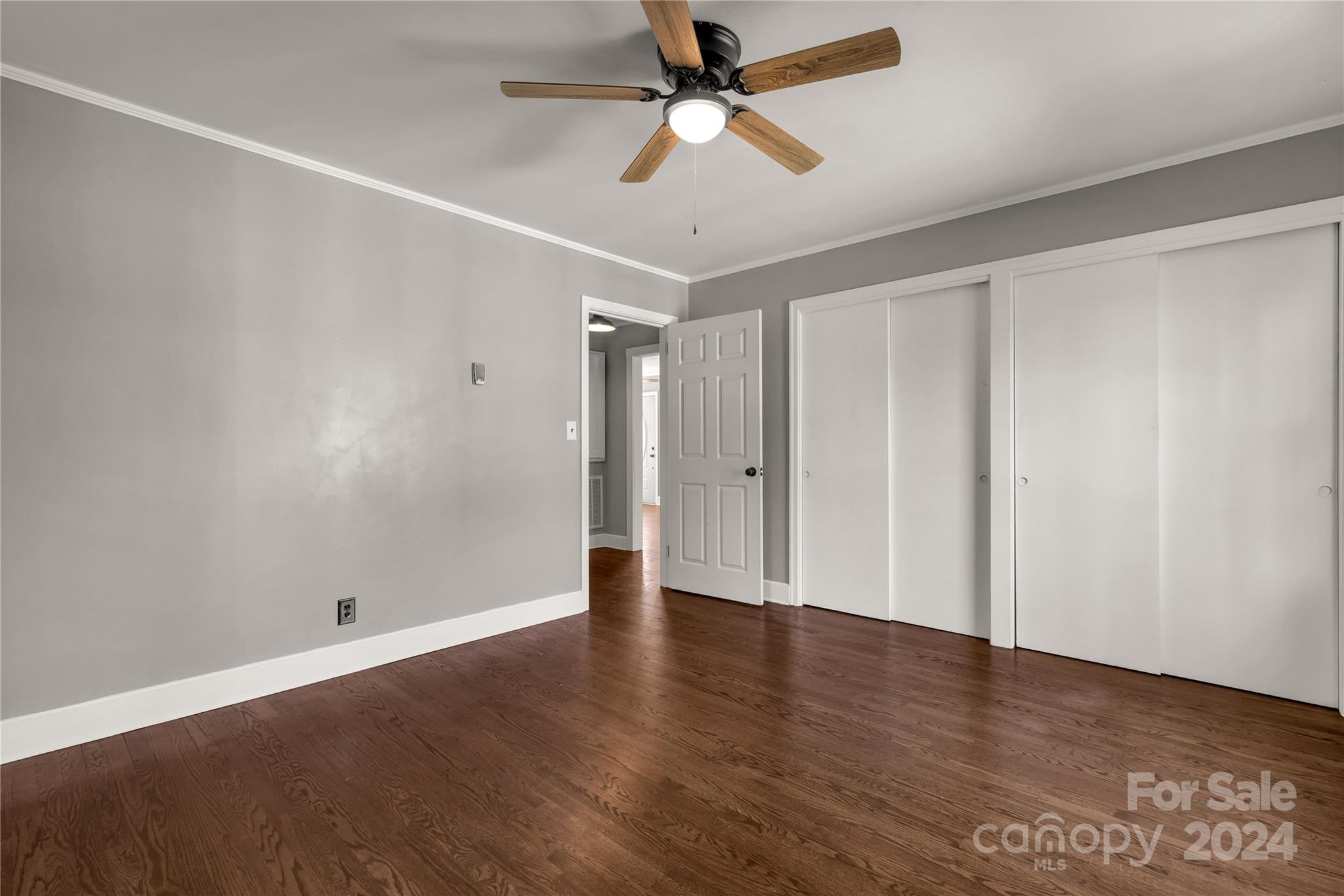 303 North White Street Lancaster, SC 29720 - Photo 14 of 24 an empty room with wooden floor fan and windows