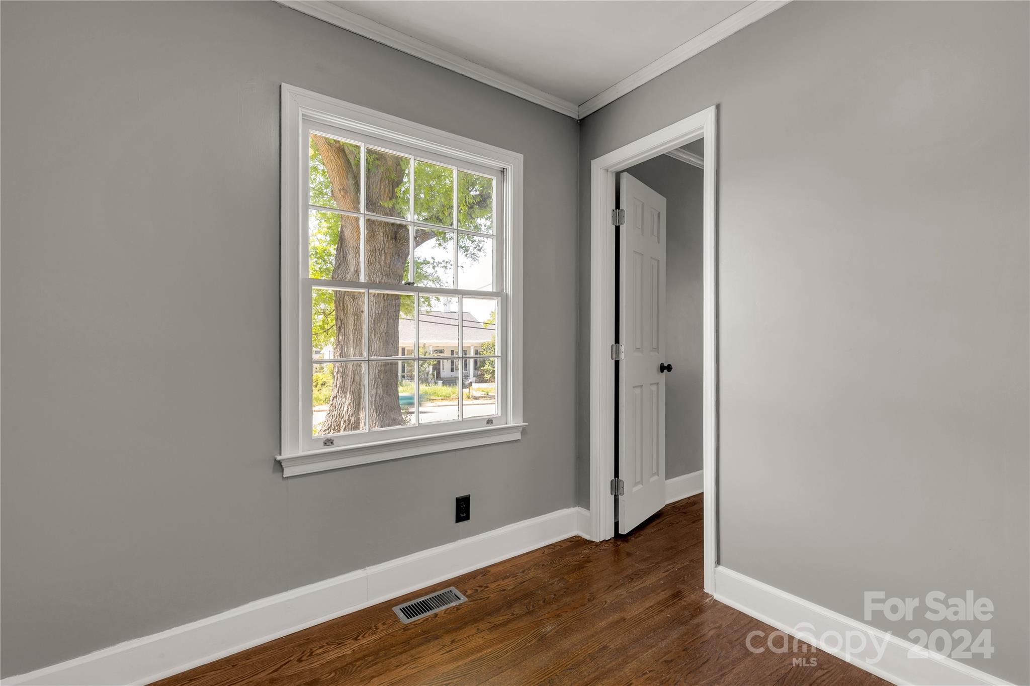303 North White Street Lancaster, SC 29720 - Photo 18 of 24 a view of an empty room with wooden floor and a window