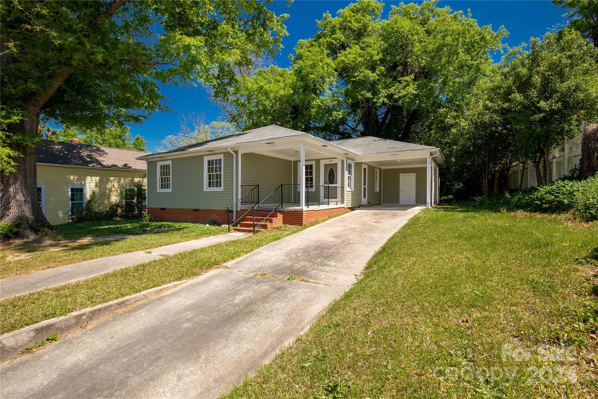 303 North White Street Lancaster, SC 29720 - Photo 2 of 24 a view of a house with a yard patio and a small yard